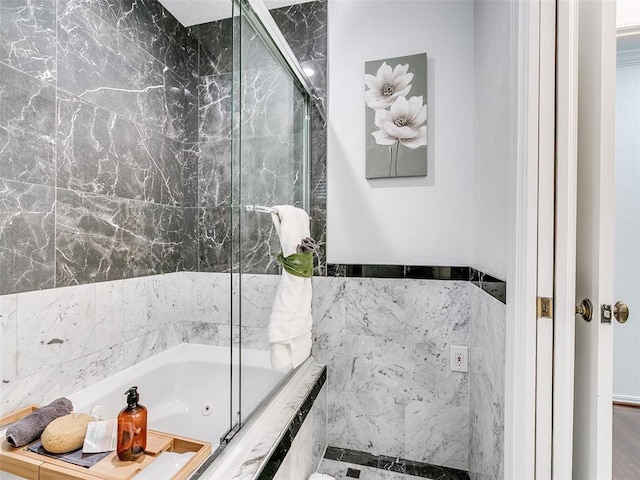 bathroom featuring a bathtub, tile walls, and a shower with shower door