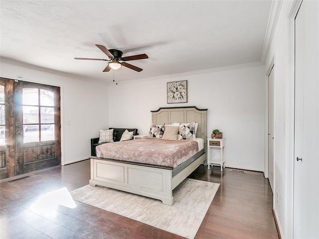 bedroom with visible vents, dark wood-style flooring, baseboards, and ornamental molding