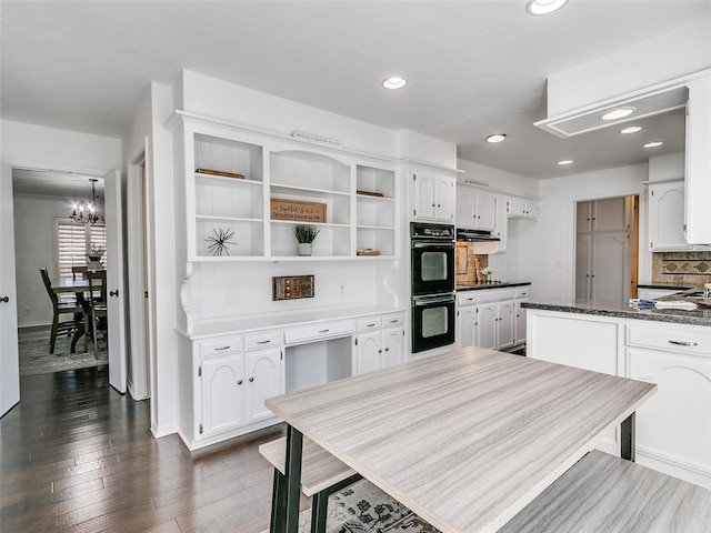 kitchen with tasteful backsplash, white cabinets, dark wood-type flooring, and dobule oven black