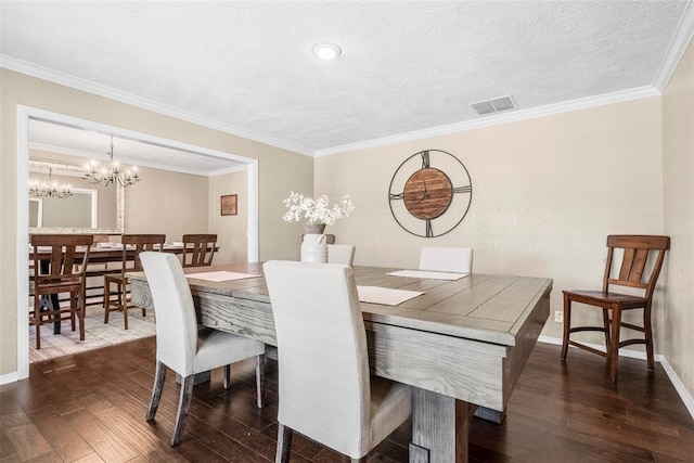 dining area featuring visible vents, baseboards, dark wood finished floors, a textured ceiling, and crown molding