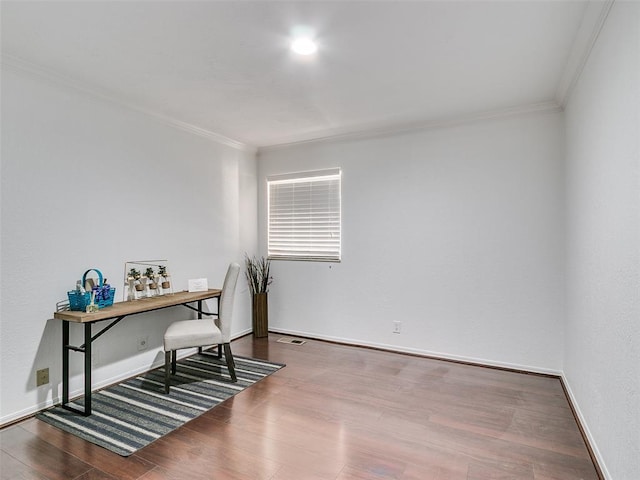 office space featuring visible vents, crown molding, baseboards, and wood finished floors