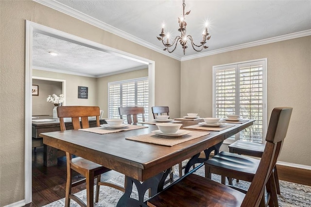 dining area featuring a chandelier, ornamental molding, baseboards, and wood finished floors