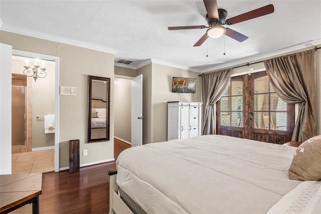 bedroom with visible vents, baseboards, wood finished floors, ornamental molding, and a textured wall