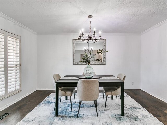 2900 Wilton Ln, Oklahoma City, OK 73120 - dining area featuring a chandelier, wood finished floors, crown molding, baseboards, and a textured ceiling