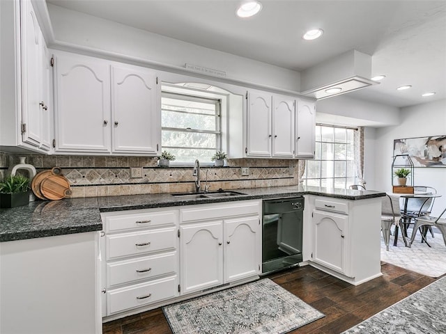 2900 Wilton Ln, Oklahoma City, OK 73120 - kitchen with dishwasher, a sink, a peninsula, white cabinetry, and backsplash