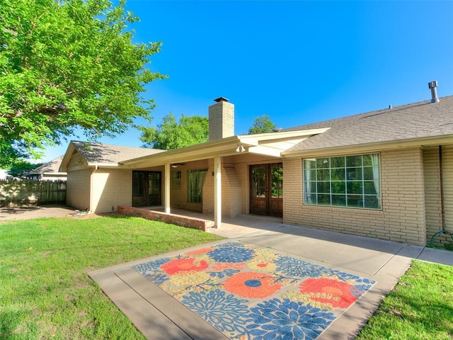 2900 Wilton Ln, Oklahoma City, OK 73120 - rear view of house featuring brick siding, a chimney, and a patio