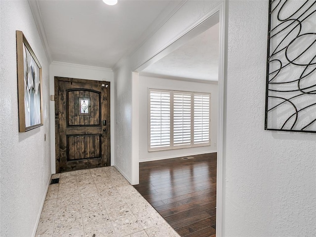 2900 Wilton Ln, Oklahoma City, OK 73120 - entrance foyer with ornamental molding, baseboards, and a textured wall