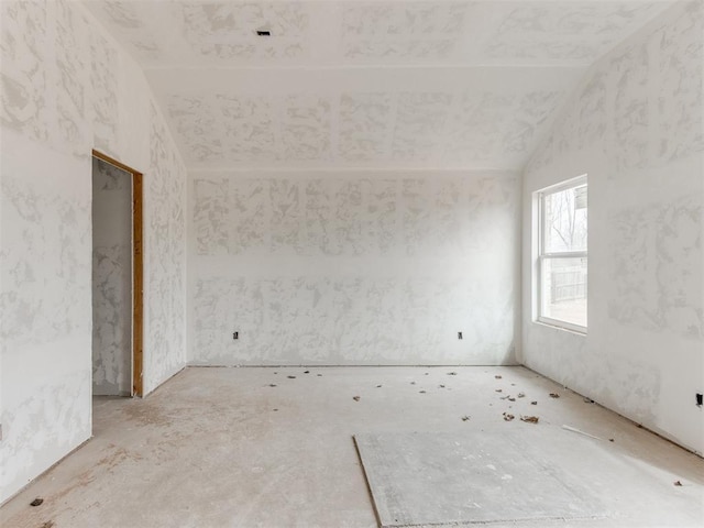 spare room featuring lofted ceiling