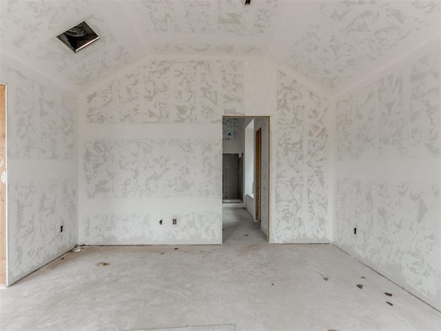 unfurnished room with vaulted ceiling