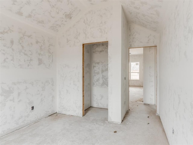 unfurnished room featuring vaulted ceiling