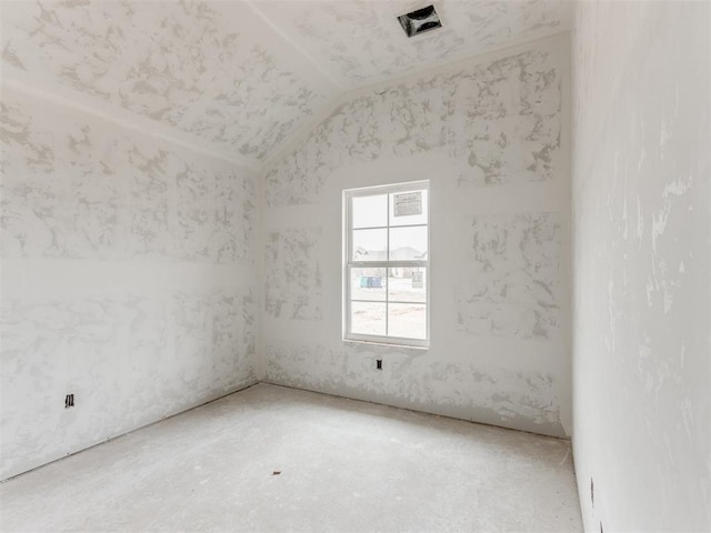 empty room featuring lofted ceiling and visible vents