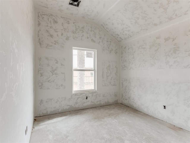 unfurnished room with vaulted ceiling