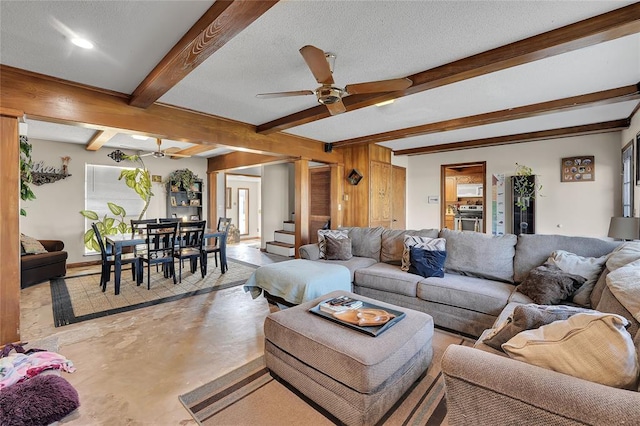 living room featuring a textured ceiling, beamed ceiling, a ceiling fan, and concrete flooring