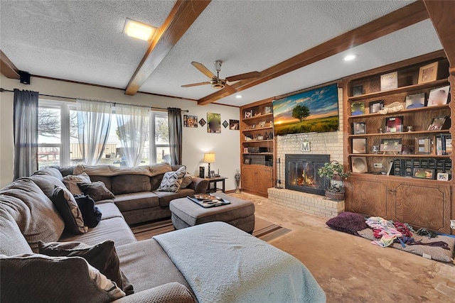 living room with built in features, beam ceiling, a fireplace, a ceiling fan, and a textured ceiling