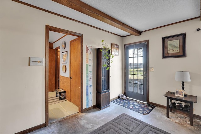 foyer entrance with beam ceiling, baseboards, a textured ceiling, and unfinished concrete floors