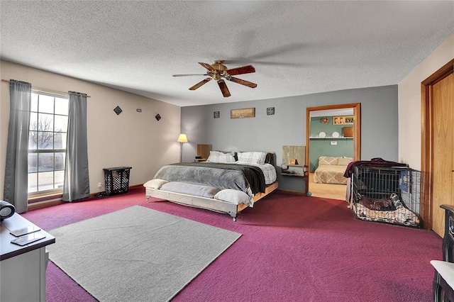 carpeted bedroom featuring a textured ceiling and a ceiling fan