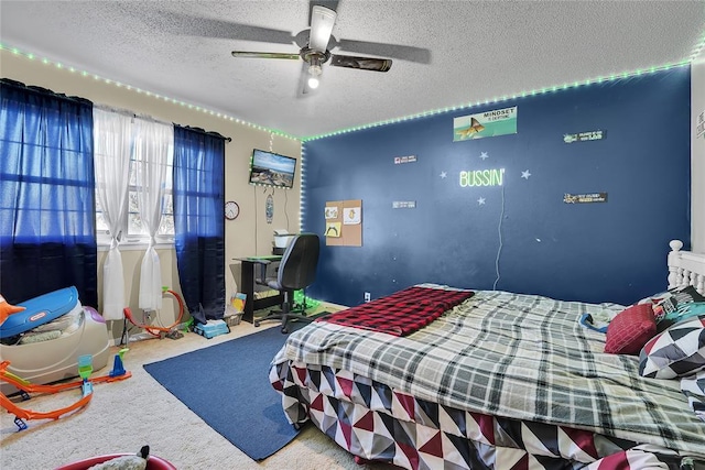 carpeted bedroom featuring a textured ceiling and a ceiling fan