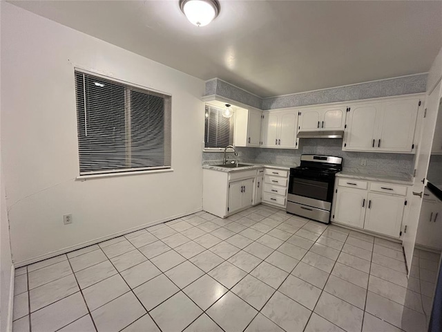 kitchen featuring light countertops, gas stove, decorative backsplash, and under cabinet range hood