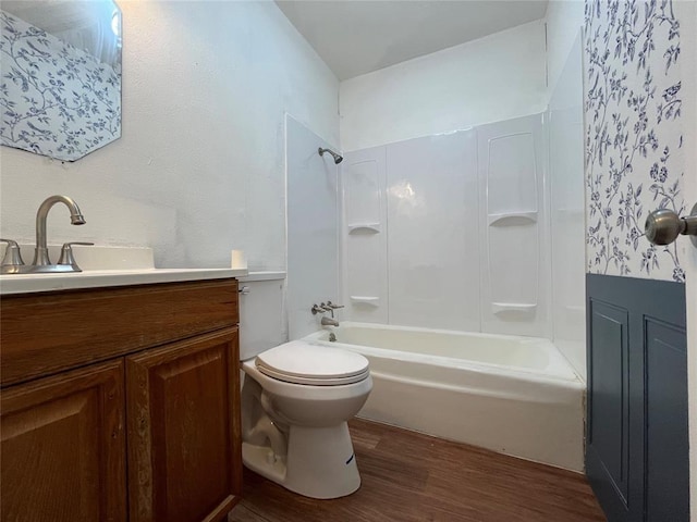 full bath with vanity, bathing tub / shower combination, wood finished floors, and toilet