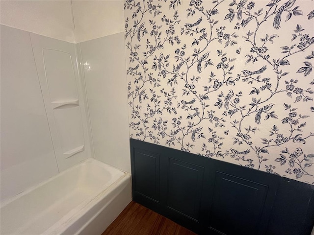 bathroom featuring shower / tub combination and wood finished floors