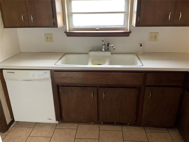 kitchen with a sink, dark brown cabinetry, light countertops, and dishwasher