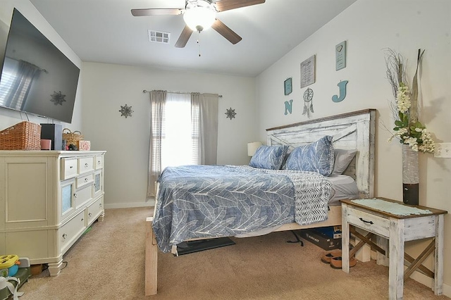 bedroom with a ceiling fan, visible vents, and light carpet