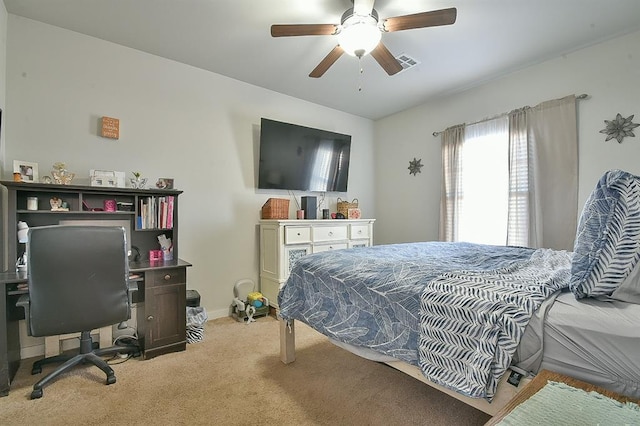 carpeted bedroom featuring baseboards, visible vents, and a ceiling fan