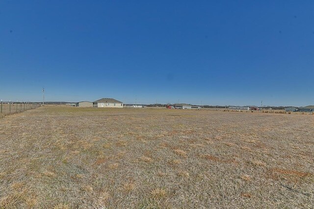 view of yard with a rural view