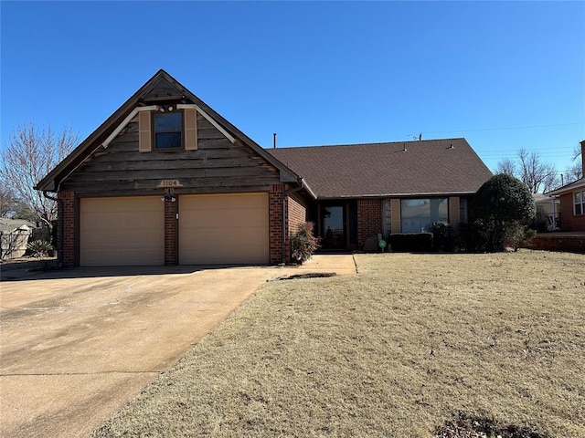 view of front of property with a garage, concrete driveway, and brick siding