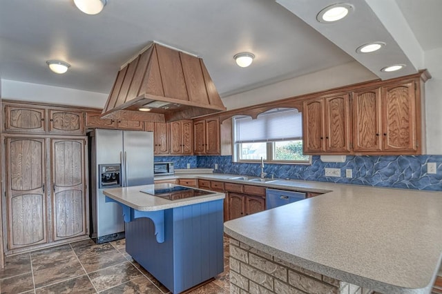 kitchen featuring black electric cooktop, a peninsula, dishwasher, stainless steel fridge, and custom range hood