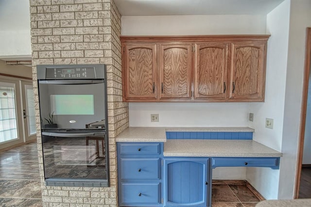 kitchen featuring multiple ovens and light countertops