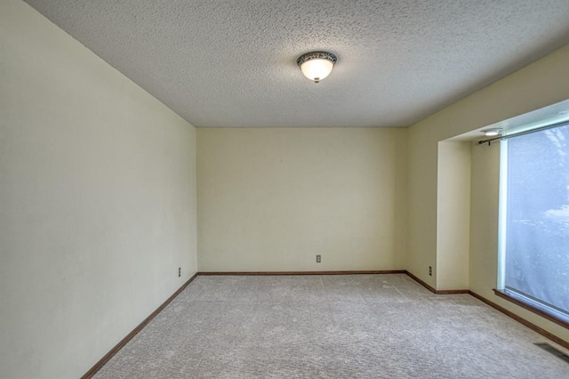 unfurnished room featuring a healthy amount of sunlight, visible vents, and light colored carpet