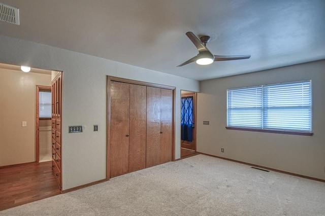 unfurnished bedroom with carpet floors, visible vents, and baseboards