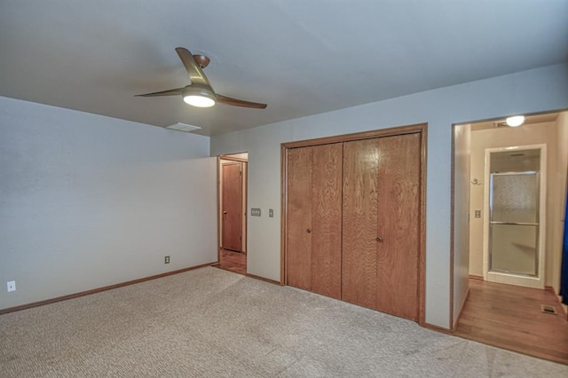 unfurnished bedroom featuring ceiling fan, carpet flooring, visible vents, baseboards, and a closet