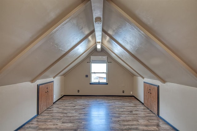 bonus room with vaulted ceiling and wood finished floors