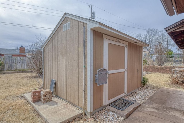 view of shed with a fenced backyard