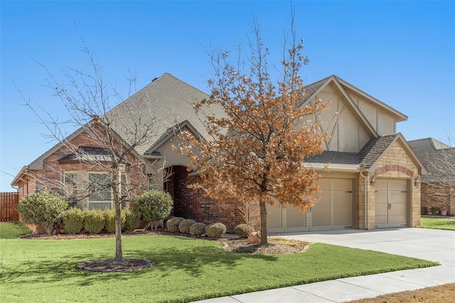 view of front of home with roof with shingles, concrete driveway, an attached garage, stone siding, and a front lawn