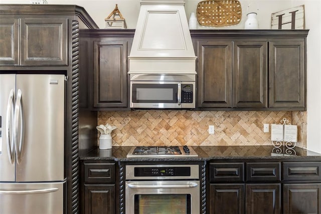 kitchen featuring stainless steel appliances, premium range hood, backsplash, and dark brown cabinetry