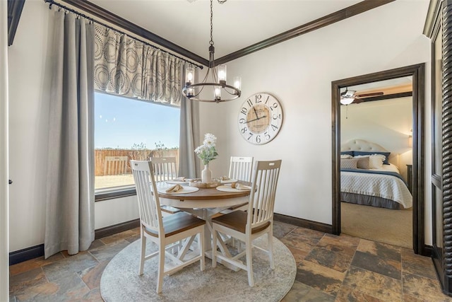 dining area featuring stone tile floors, baseboards, a chandelier, and crown molding