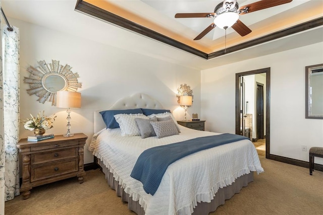 bedroom with light carpet, ceiling fan, a raised ceiling, and baseboards