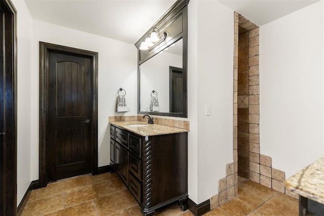 bathroom featuring vanity and baseboards