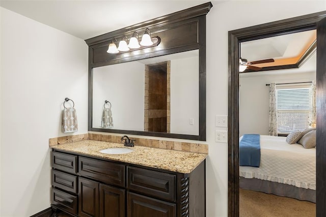 ensuite bathroom with ceiling fan, connected bathroom, and vanity