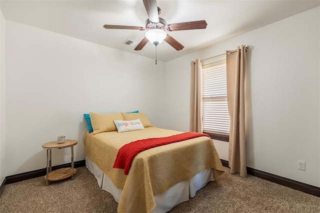 carpeted bedroom with baseboards, visible vents, and a ceiling fan