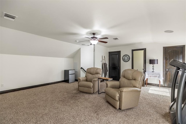 carpeted living area with vaulted ceiling, ceiling fan, visible vents, and baseboards