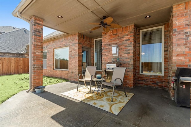 view of patio with ceiling fan and fence