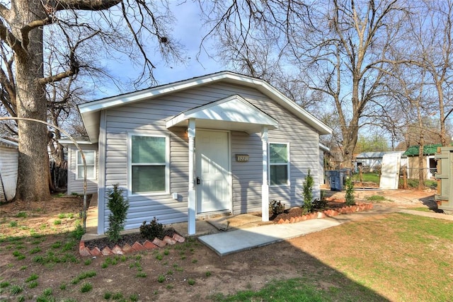 bungalow-style house with fence