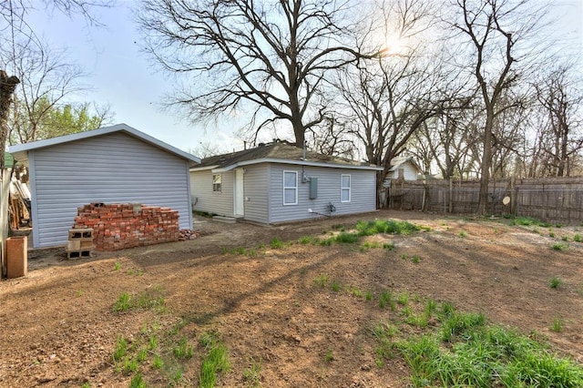 rear view of house featuring fence