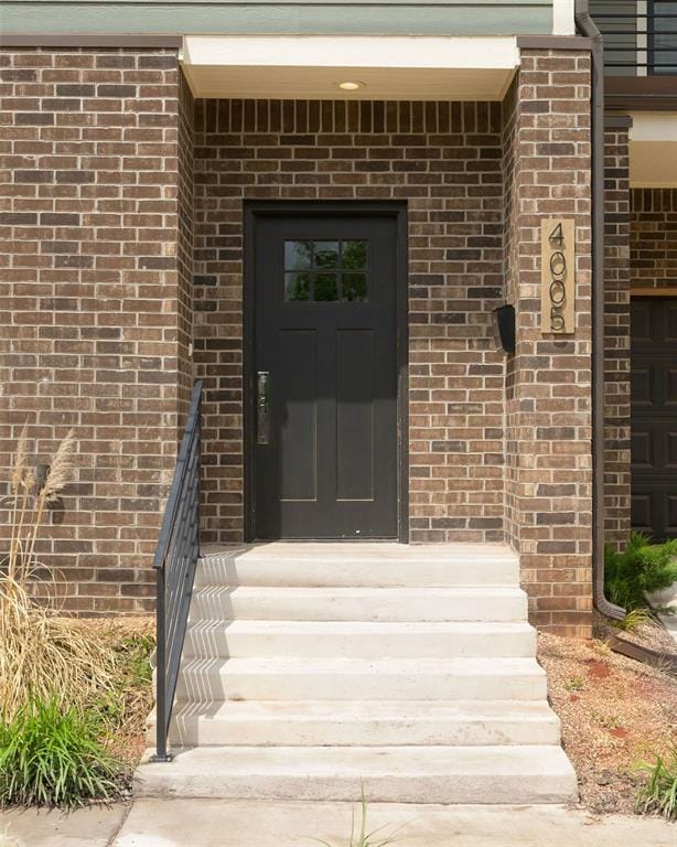 property entrance with brick siding