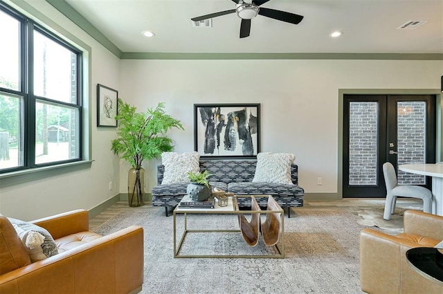 living area with french doors, recessed lighting, visible vents, wood finished floors, and baseboards