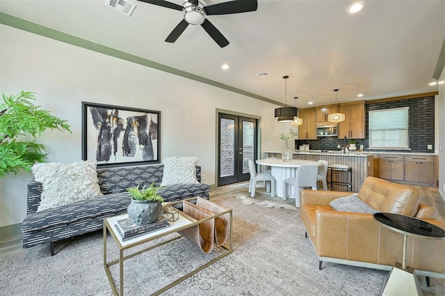 living room with recessed lighting, french doors, and visible vents